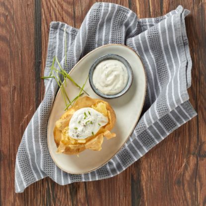 Bild von Baked Potatoes FRISCH & gegart, 250g/St mit der Beschreibung Aus gesunden &  reifen Speisekartoffeln. Ideal als Beilage oder Solo mit leckerer Kartoffelcreme.