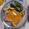 Bild von Hähnchenbrustfilet in Knusperpanade 150g mit der Beschreibung Zartes, saftiges Hähnchen-Knusperfilet mit knuspriger Cornflaks-Panade.